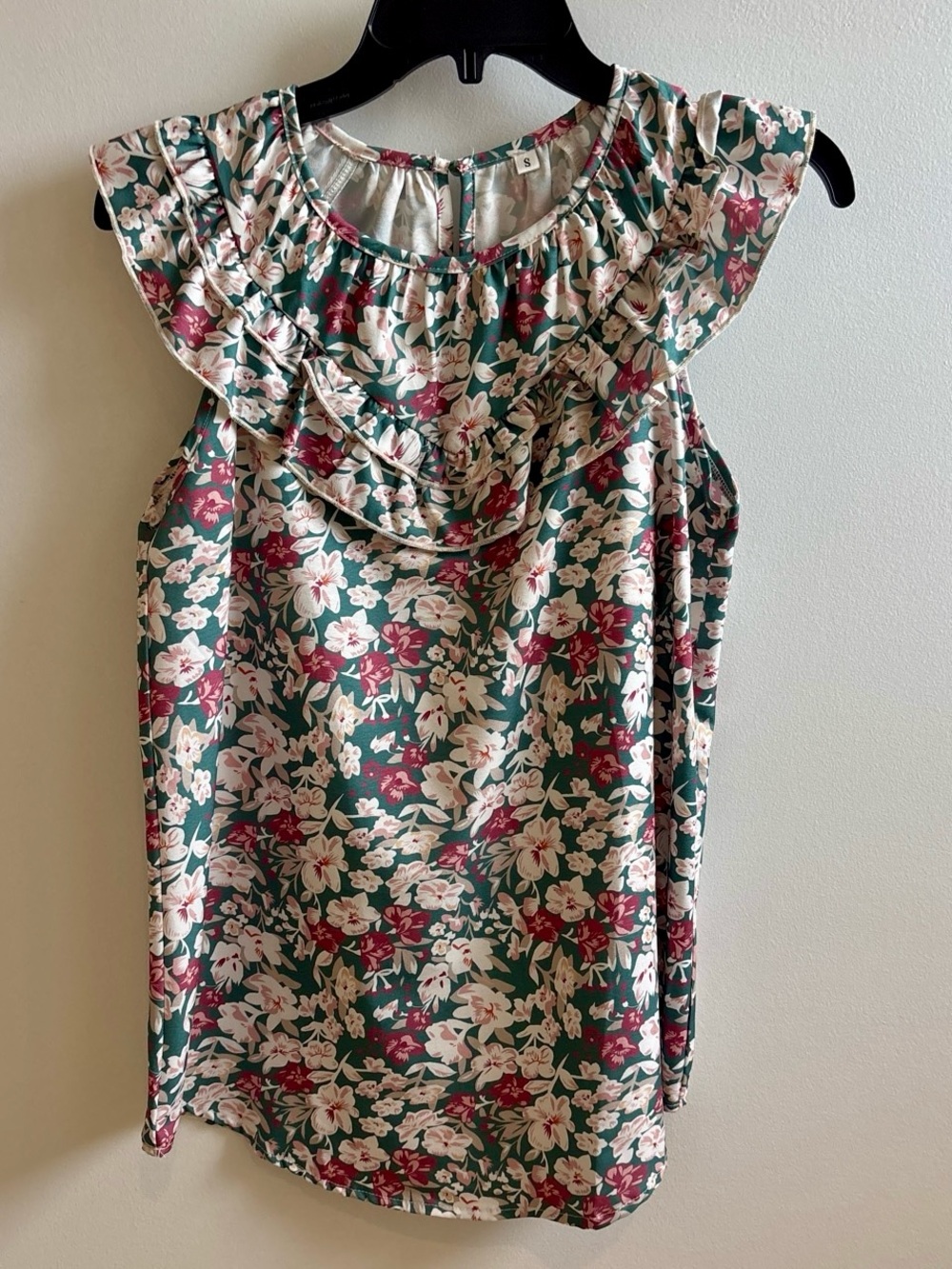 Floral blouse with ruffle detail on chest. NWOT